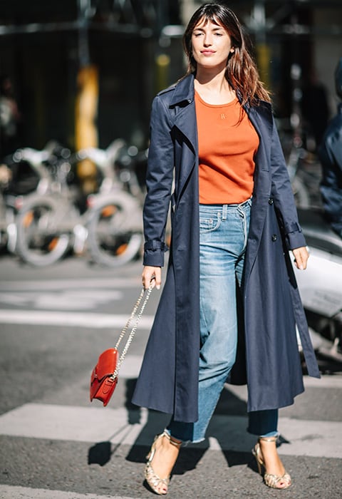 Jeanne Damas with navy trench coat, cropped jeans and heeled sandals 