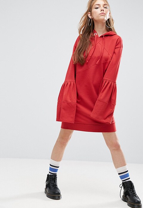 model wearing ASOS hoodie dress with bell sleeves, available at ASOS