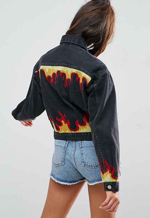 model wearing ASOS Denim Girlfriend Jacket in Washed Black with Flame Embroidery, available at ASOS