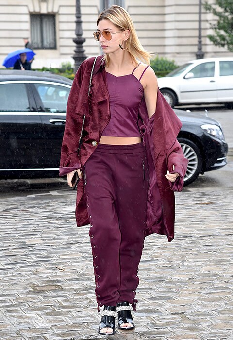 Hailey Baldwin wearing head-to-toe burgundy outfit with cami top, joggers and oversized jacket
