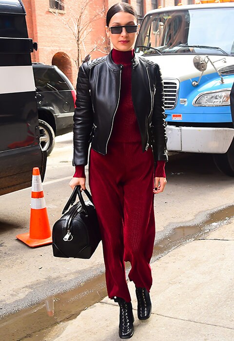 Bella Hadid wearing burgundy co-ord, a leather jacket and lace-up boots