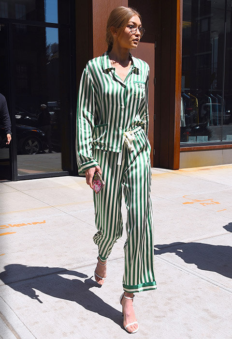 Gigi Hadid wearing silk stripe pyjama style co-ord and barely-there sandal heels