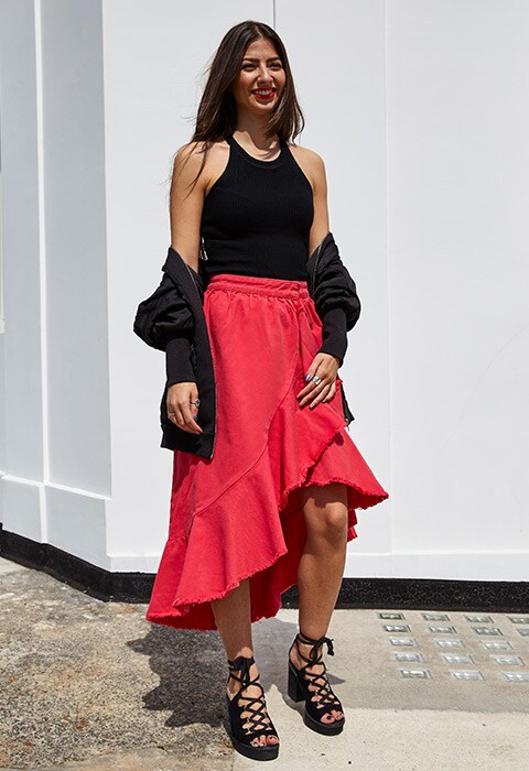 Laura Shehata ASOS picture editor wearing black knit vest, red denim flamenco skirt and heeled sandals | ASOS Fashion and Beauty Feed
