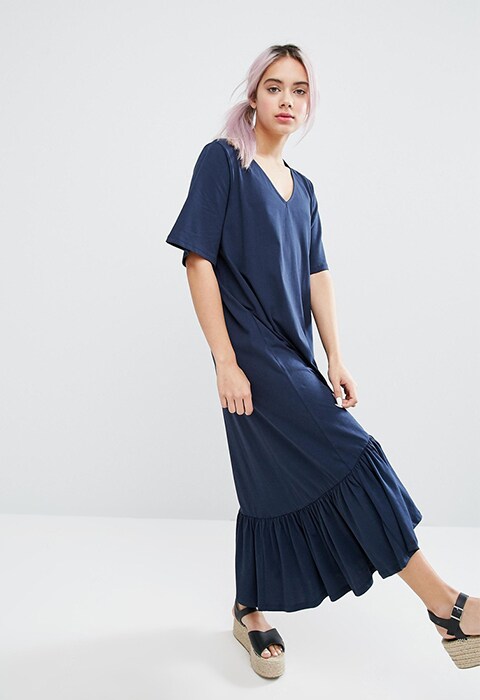 Model wearing blue Monki V-neck, ruffle-hem dress, available in the ASOS sale now | ASOS Fashion & Beauty Feed