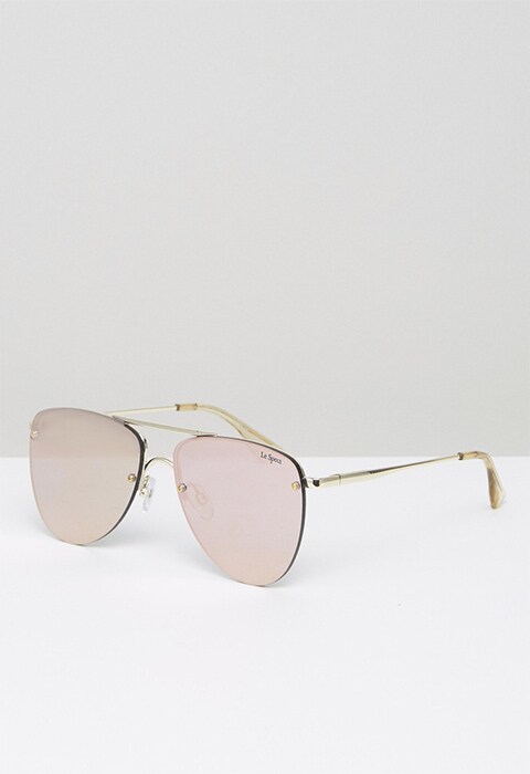 Model wearing Le Specs flat-lens aviator sunglasses in rose gold, available at ASOS | ASOS Fashion & Beauty Feed