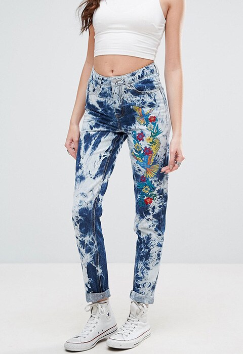 model wearing Glamorous Festival Acid Wash Mom Jeans With Embroidery, available on ASOS