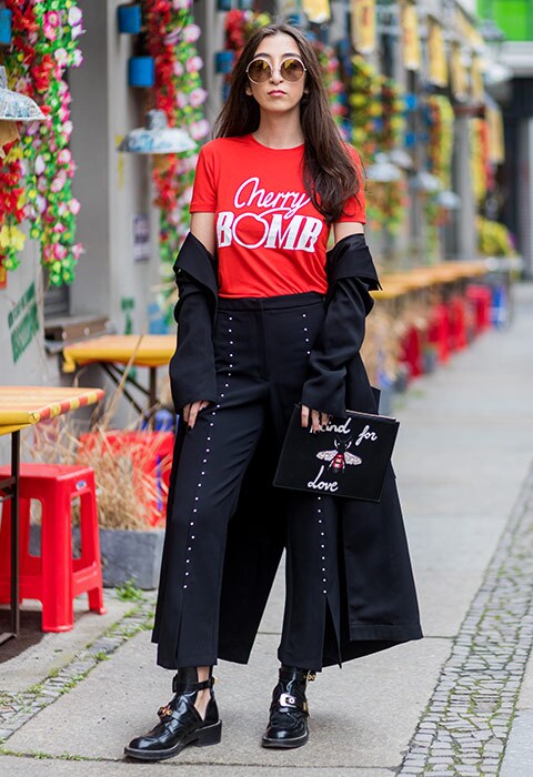 Street style star Nadja Ali wearing cherry bomb T-shirt, eyelet trousers, Balenciaga boots and clutch bag | ASOS Fashion and Beauty Feed