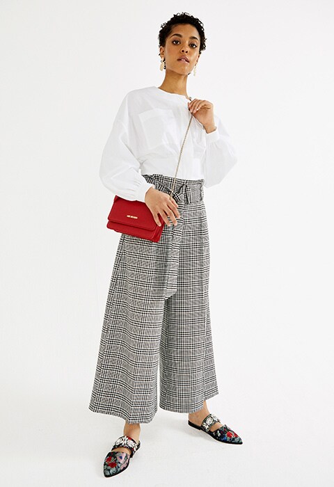 Wide-legged pants and backless loafers
