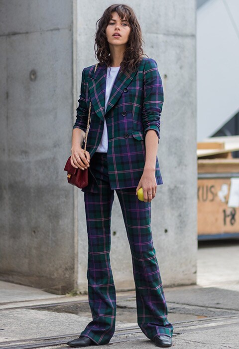 Model Georgia Fowler wearing green and purple check suit