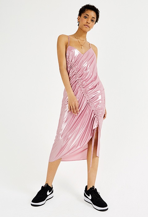 Model wearing ASOS pink midi dress with rouching detail styled with black Nike trainers and layered gold necklaces | ASOS Fashion & Beauty Feed