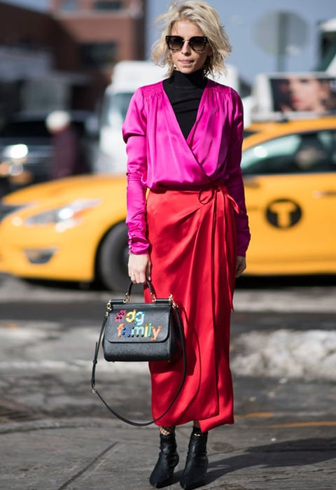 Street Styler Caroline Daur wearing satin pink blouse and satin red wrap skirt | ASOS Fashion & Beauty Feed