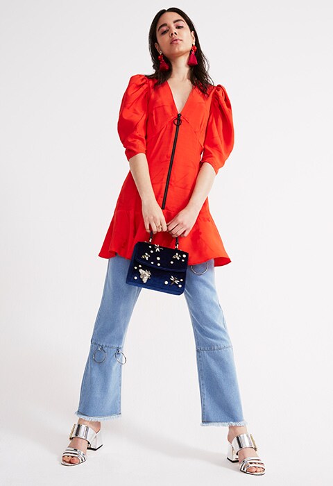 Model wearing 80s red dress over jeans | ASOS Fashion & Beauty Feed