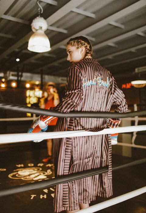 YouTube blogger Marie Novosad wearing an oversized, stripe robe with boxing gloves | ASOS Fashion & Beauty Feed