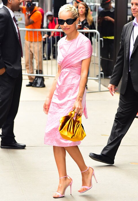 Zoe Kravitz wearing a pink dress and The Row gold bag | ASOS Fashion & Beauty Feed