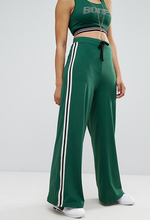 model wearing Bones Wide Leg Tracksuit Bottoms With Contrast Side Stripe, available at ASOS