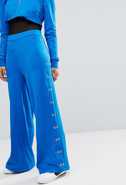 model wearing Bones Wide Leg Tracksuit Bottoms With Eyelet Detail, available on ASOS