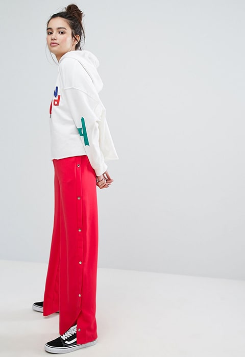 model wearing H! By Henry Holland Wide Leg Tracksuit Bottoms With Poppers, available on ASOS