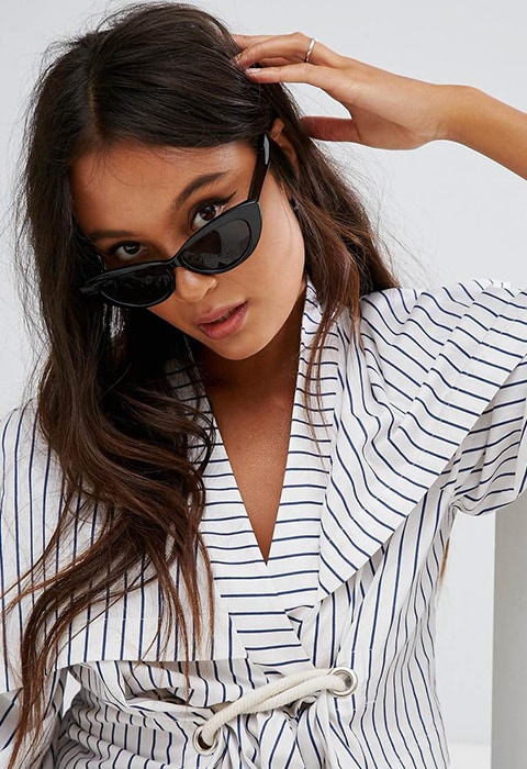 Model wearing black ASOS small pointy cat-eye sunglasses, available at ASOS | ASOS Fashion & Beauty Feed