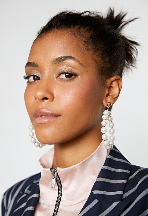 Model wearing a pinstripe blazer and pearl earrings | ASOS Fashion & Beauty Feed