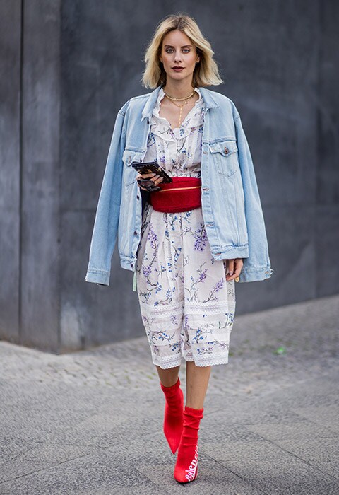 Blogger and street style star Lisa Hahnbueck wearing red bumbag and Louis Vuitton x Supreme boots with dress and denim jacket | ASOS Fashion and Beauty Feed