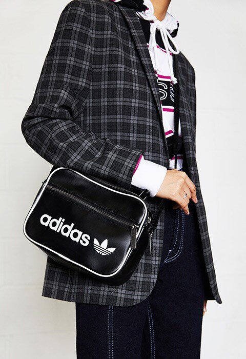Model wearing a hoodie and adidas bag | ASOS Fashion & Beauty Feed