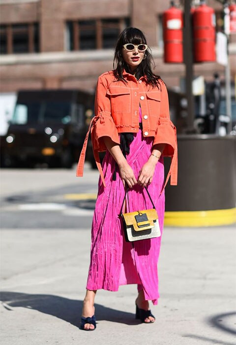 Street-styler wearing a crinkle pink skirt and fuchsia jacket at NYFW | ASOS Fashion & Beauty Feed