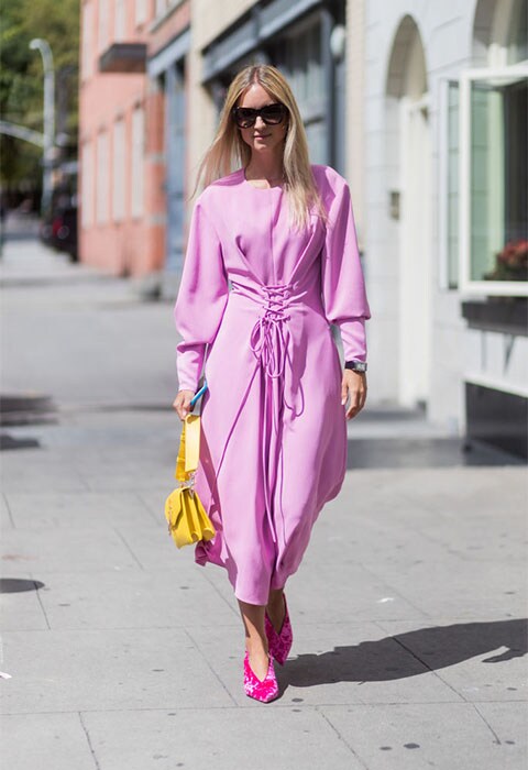 Street-styler wearing a pink dress with corset-tie waist at NYFW | ASOS Fashion & Beauty Feed