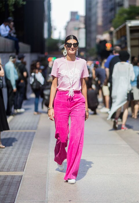  Street-styler wearing a rose tee and hot-pink corduroy flares at NYFW | ASOS Fashion & Beauty Feed