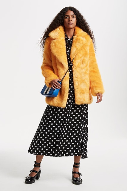 Model Laetitia wearing a mustard faux-fur coat | ASOS Fashion & Beauty Feed