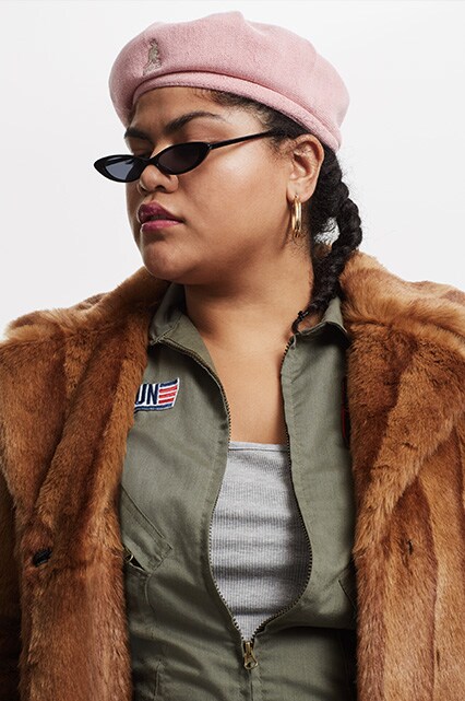 Artist Al Ly wearing a brown faux fur coat | ASOS Fashion & Beauty Feed