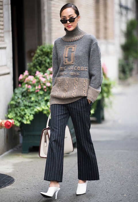 Street style star wearing a knit jumper and tailored trousers | ASOS Style Feed