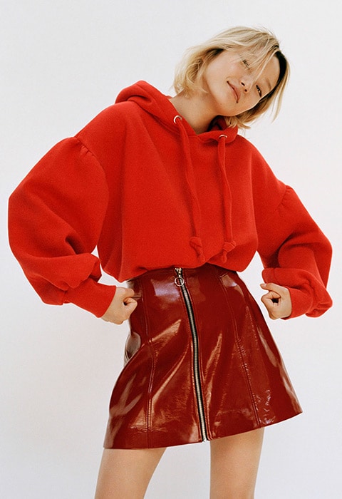 Model wearing a Bershka hoodie and vinyl skirt | ASOS Style Feed