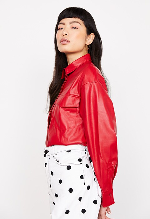 Model wearing a leather shirt and polka dot mom jeans
