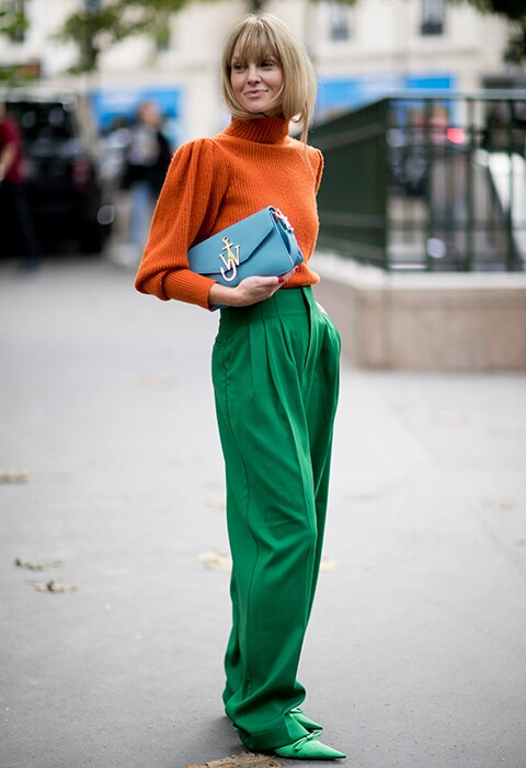Blogger wearing an orange roll neck and green trousers