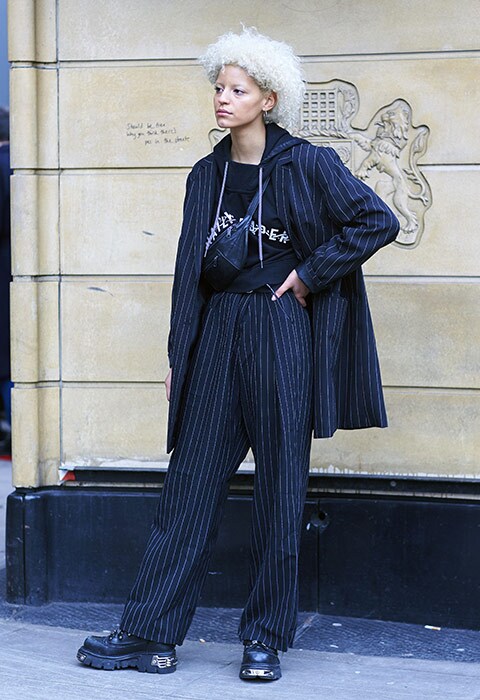 Street style goer wearing pinstripe suit at London Fashion Week Men's Autumn/Winter 2018