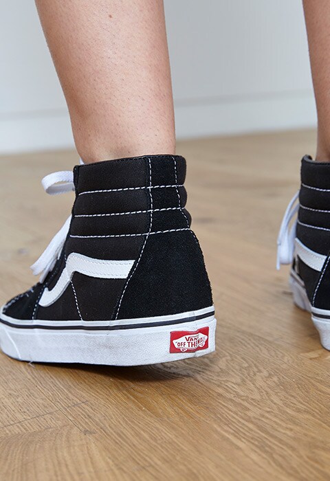 ASOS staff wearing Vans hi-tops with a cow-print co-ord