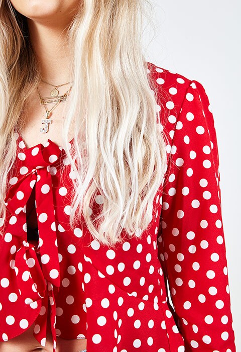 ASOS staff wearing a red polka dot top