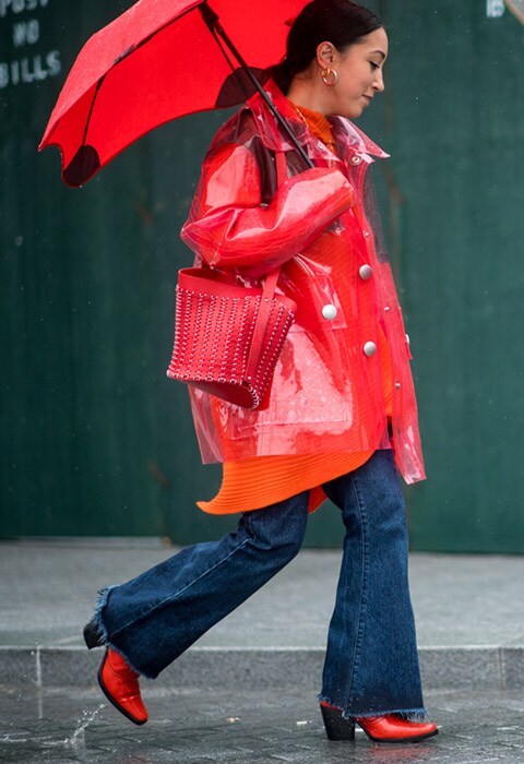 Street-style star wearing a red plastic mac at NYFW AW18