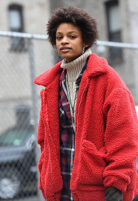 Street-style star wearing a red shearling jacket at NYFW AW18