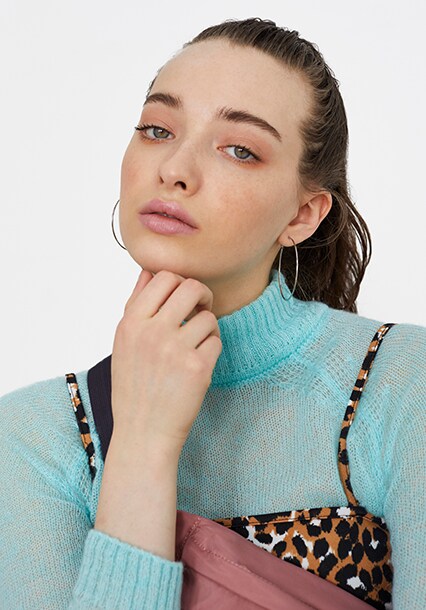 Model wearing a turquoise roll neck, available at ASOS