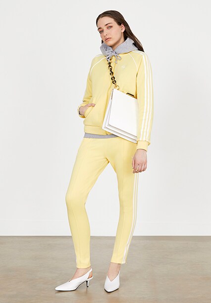 Model wearing a yellow tracksuit, available at ASOS
