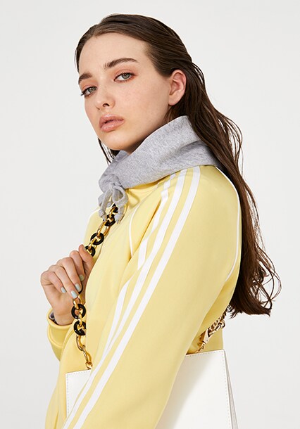Model wearing a yellow tracksuit, available at ASOS