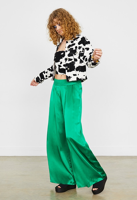 Model wearing cow-print denim available at ASOS