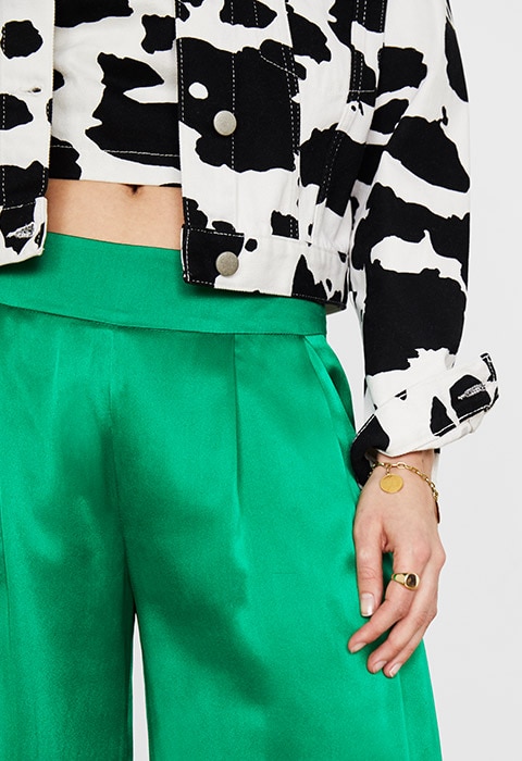 Model wearing cow-print denim available at ASOS