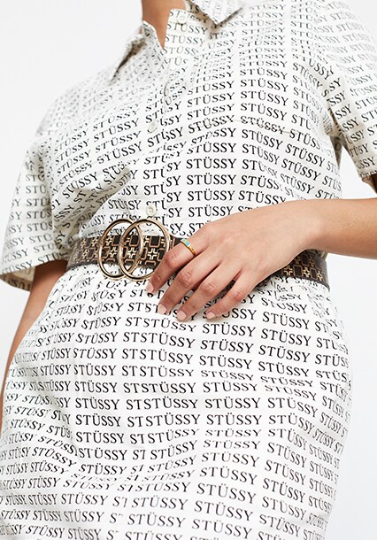 Model wearing Stussy logo shirt dress, available at ASOS