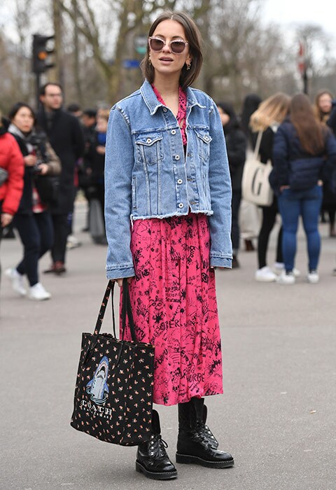 Paris Fashion Week goer wearing a graffiti dress and denim jacket