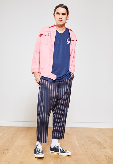 Matt Glazebook wearing a football shirt and pink jacket, available at ASOS
