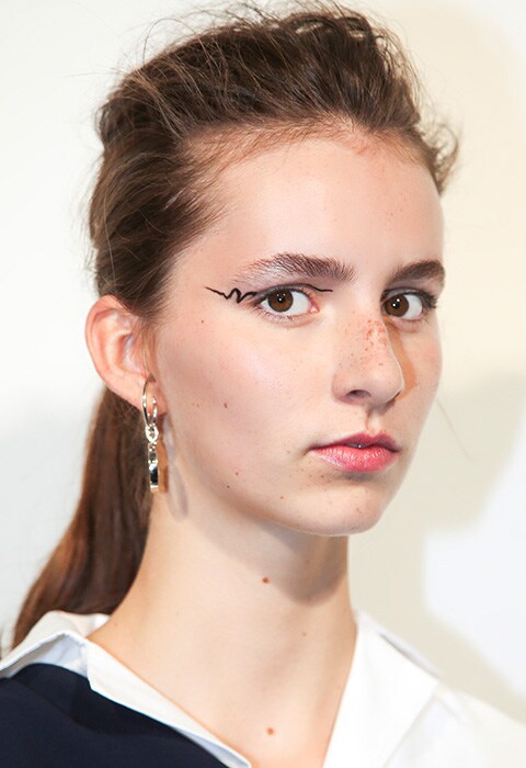 Models backstage at the Eudon Choi SS18 show with graphic eyeliner