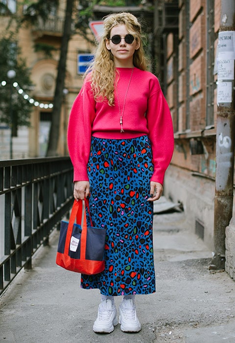Street styler wearing a leopard-print skirt and pink jumper
