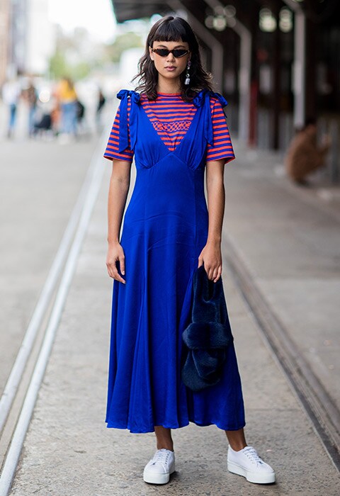 Street styler wearing summer stripes and a royal-blue midi dress